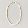 Full view of a men's 7-8mm freshwater pearl beaded necklace arranged in an oval on a light gray studio background.
