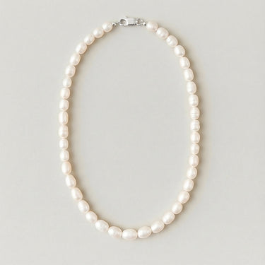Full view of a men's 7-8mm freshwater pearl beaded necklace arranged in an oval on a light gray studio background.