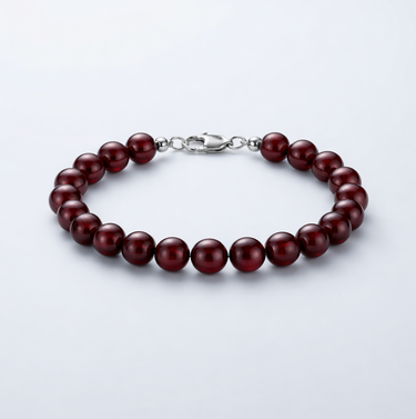 An 8mm Garnet round bead bracelet with a high-polish silver lobster clasp, highlighting the natural stone depth and polished finish.
