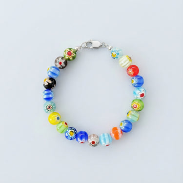 An 8mm handmade Millefiori glass bead bracelet with intricate floral designs and a high-polish silver lobster clasp.
