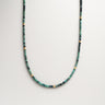 Men's 2-3mm faceted green and teal tourmaline cube beads with gold spacer beads, displayed in a U-shape against a neutral background.
