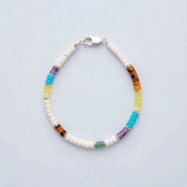 A 4mm multi-gemstone heishi bead bracelet featuring turquoise, amethyst, and tiger's eye with sterling silver roundel accents and a silver clasp.
