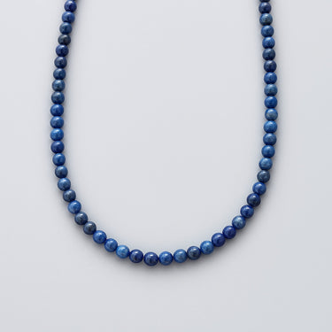 A single strand of 6mm royal blue Lapis Lazuli beads displayed in a U-shape against a neutral background.
