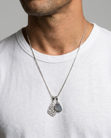 mens silver amulet pendant necklace styled on model with white tshirt modern urban look