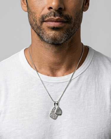 mens silver amulet pendant necklace styled on model with white tshirt modern minimalist look