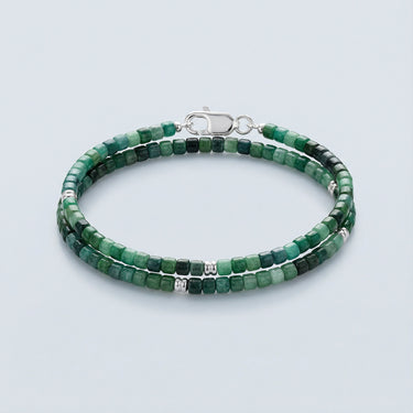 Men's 2-3mm faceted green and teal tourmaline cube beads with sterling silver spacer beads, displayed in a coiled-shape against a neutral background.
