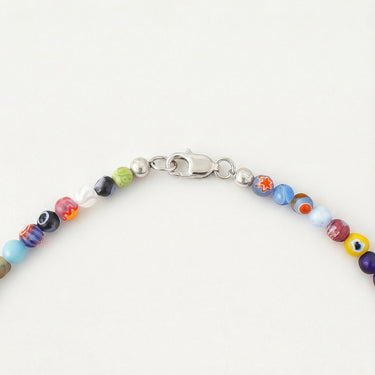 A close-up detailed shot focusing on a high-polish silver lobster clasp attached to a strand of 4mm multi-colored Millefiori glass beads against a white background.
