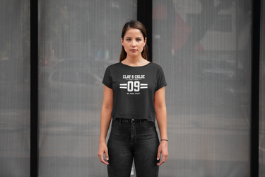 model wearing black crop top with white font Clay and Chloe logo