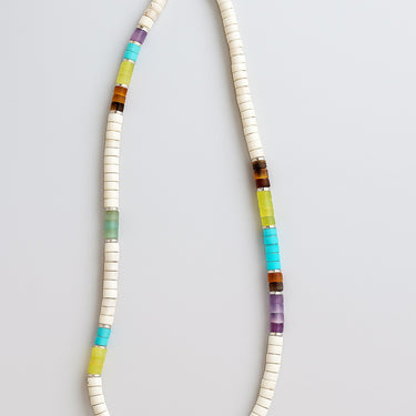 A macro close-up highlighting the transition between different gemstone heishi beads and sterling silver spacers.
