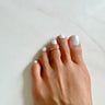 Foot model wearing 14K Rose-Gold Filled Adjustable Overlap midi Toe Ring on the middle toe. Slightly hammered to give texture and style.