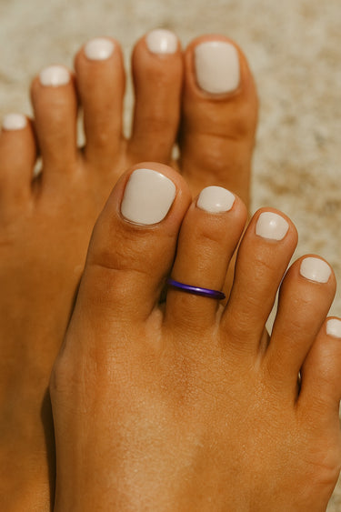 Side angle of purple anodized aluminum toe ring — smooth rounded edges for comfortable everyday wear.