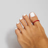 Red anodized aluminum big toe ring on toes — smooth rounded fit and bold color, COLORS Collection by Clay & Chloe Jewelry.