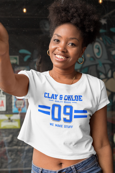 model wearing white crop top with blue font Clay and Chloe logo