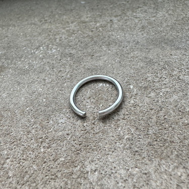 Silver ring on a textured gray surface
