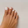 Sorbet pink anodized aluminum toe ring on toes — smooth rounded fit, COLORS Collection by Clay & Chloe Jewelry.