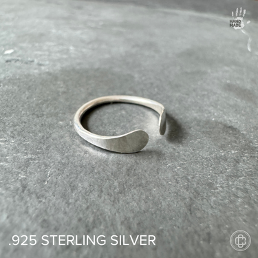 sterling silver cuff toe ring, adjustable, on a dark background