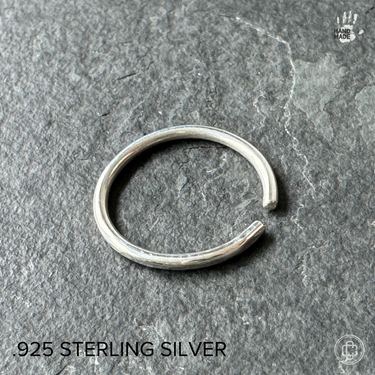 classicic sterling silver toe ring on a dark background
