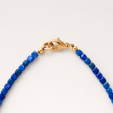 A macro detail view of the 3mm Lapis Lazuli cube beads meeting professional-grade 14K gold-filled hardware, featuring a secure and high-polish gold lobster clasp.

