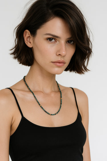 A portrait-view lifestyle shot of a model wearing the 3mm Tourmaline necklace, demonstrating its refined presence and modern luxury silhouette.
