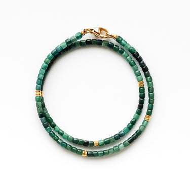 A studio hero shot of a women's 3mm natural faceted tourmaline cube wrap bracelet featuring 14K gold-filled bead accents, highlighting the multi-tonal green gemstones and elegant layered design.
