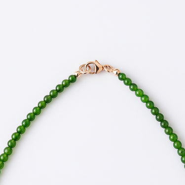 A macro detail view of the 4mm Jade beads meeting professional-grade 14K gold-filled hardware, featuring a secure and high-polish lobster clasp.
