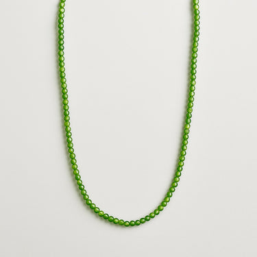 A professional studio hero shot of the women's 4mm Jade necklace arranged in a U-shape against a neutral background, highlighting the uniform scale and soft green translucency of the round beads.
