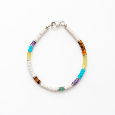 A studio hero shot of a 4mm mixed gemstone heishi bracelet featuring white turquoise, tiger's eye, and amethyst, with sterling silver flat rondel beads for a refined, colorful aesthetic.
