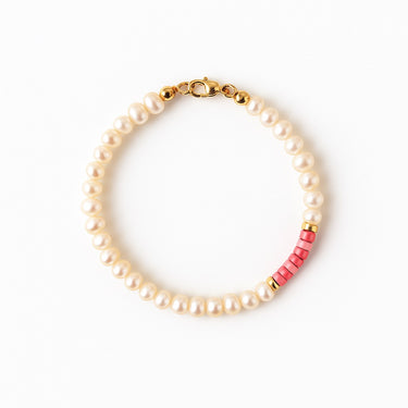 A studio hero shot of a women's 4mm natural pearl and rhodonite bead bracelet with a 14K gold-filled clasp, featuring high-luster pearls accented by soft pink gemstone tones.
