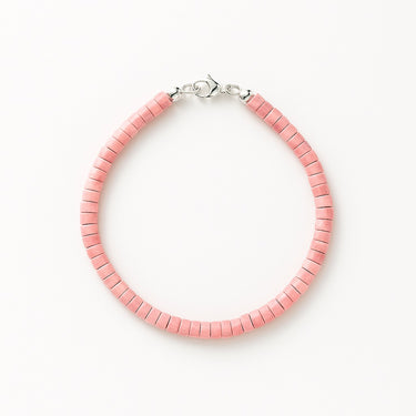 A studio hero shot of a women's 4mm natural rhodonite heishi bead bracelet with a sterling silver lobster clasp, highlighting the soft rose-pink gemstone tones and uniform disk-shaped stones.
