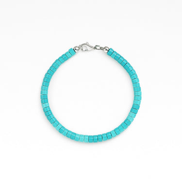 A studio hero shot of a 4mm turquoise heishi bead bracelet with a sterling silver lobster clasp, showcasing the uniform disk shape and natural semi-precious stone texture.
