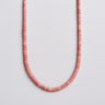 A 4mm Pink Petrified Rhodonite heishi bead necklace featuring a dusty rose hue and natural stone variations, displayed in a U-shape.
