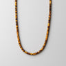 A professional studio hero shot of the women's 4mm Tiger's Eye heishi bead necklace arranged in a U-shape against a neutral background, highlighting the uniform disc shape and golden chatoyancy of the stones.
