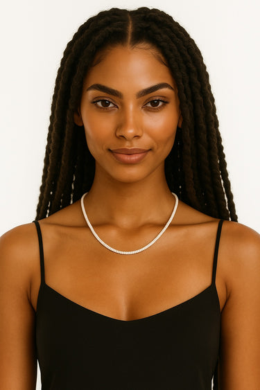 An editorial lifestyle shot of a woman wearing the 4mm white turquoise necklace, highlighting the minimalist silhouette and natural stone texture.
