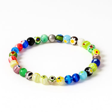 A perspective studio shot of the 6mm Millefiori glass bead bracelet, emphasizing the uniform round shape and the sophisticated contrast provided by the gold-filled metallic accent.

