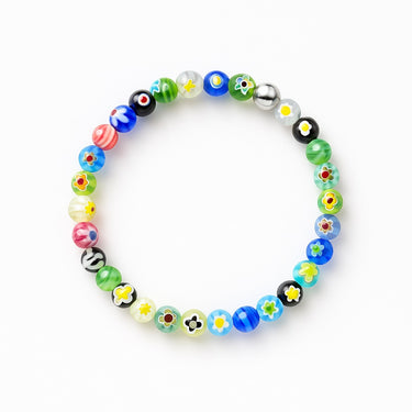 A studio hero shot of a 6mm Millefiori glass bead bracelet featuring a 14K gold-filled accent bead, highlighting the intricate floral details and high-luster finish of the handmade glass.
