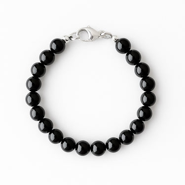 A studio hero shot of an 8mm gloss black onyx bead bracelet featuring a structural sterling silver lobster clasp, arranged in a clean circular form on a white background.
