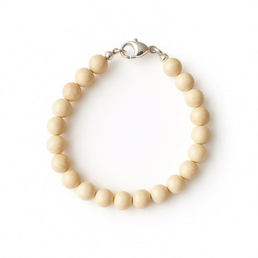 A studio hero shot of a women's 8mm natural fossil jasper bead bracelet with a sterling silver lobster clasp, highlighting the organic earth-toned patterns and matte stone finish.
