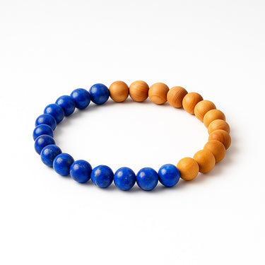 A studio hero shot of an 8mm natural lapis lazuli and golden sandalwood bead bracelet, highlighting the contrast between the deep royal blue gemstones and the warm, matte wood texture.
