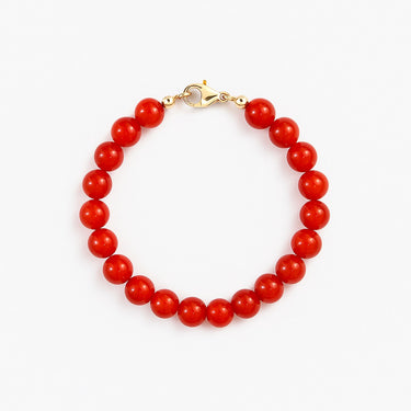 A studio hero shot of a women's 8mm natural red agate bead bracelet with a 14K gold-filled lobster clasp, highlighting the vibrant crimson tones and high-polish finish.
