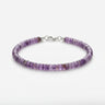 A studio product shot of a women's 4mm natural amethyst heishi bead bracelet with a sterling silver lobster clasp, showcasing the vibrant purple gemstone tones and refined, uniform disk shape.
