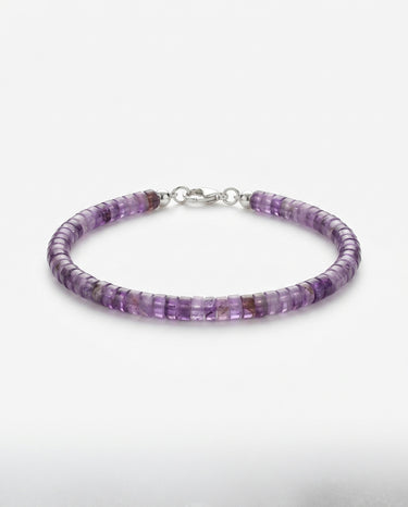 A studio product shot of a women's 4mm natural amethyst heishi bead bracelet with a sterling silver lobster clasp, showcasing the vibrant purple gemstone tones and refined, uniform disk shape.
