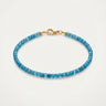 A studio product shot of a women's AAA natural teal blue apatite faceted 2-3mm cube beads bracelet with 14k gold-filled lobster clasp.