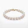 A studio product shot of a 7-8mm natural white baroque freshwater pearl bracelet with a 14K gold-filled clasp, highlighting the individual character and high-shine finish of each pearl.