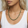 Woman wearing a chrome diopside beaded necklace against a neutral background