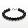 A studio product shot of a women's 8mm natural gloss onyx bead bracelet with a sterling silver lobster clasp.