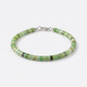 A studio product shot of a woman's 4mm African green chrysoprase heishi bead bracelet featuring a genuine sterling silver lobster clasp, highlighting the disk shape and matte natural stone texture.