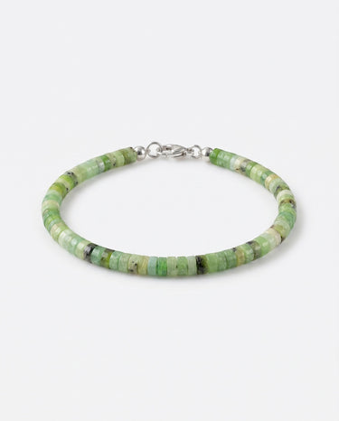A studio product shot of a woman's 4mm African green chrysoprase heishi bead bracelet featuring a genuine sterling silver lobster clasp, highlighting the disk shape and matte natural stone texture.