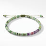 Studio product shot of adjustable chrysoprase heishi bracelet with sterling silver accents, amethyst and pink rhodonite beads, sliding knot closure, and gemstone dangles.
