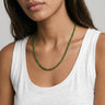 woman with a white tank top wearing 4mm round green jade beaded necklace against a plain background