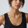 Woman wearing a lemon jade heishi bead necklace styled with a black tank top.